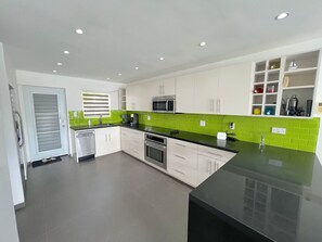 Modern kitchen with ample workspace, storage solutions, and sleek appliances.