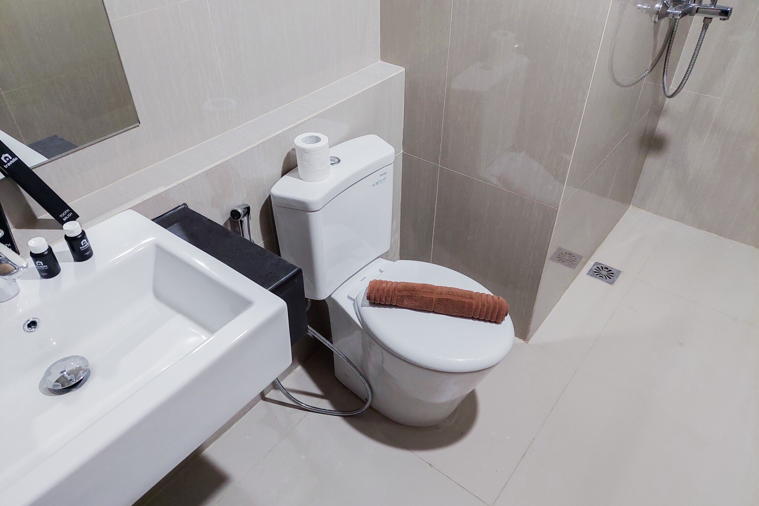 A modern bathroom with a white sink, toilet, and shower.
