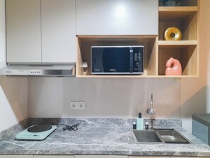 Deluxe Apartment (kingbed) | Private kitchen - Comfort Stay 1BR at Patraland Amarta Apartment (Ngaglik)