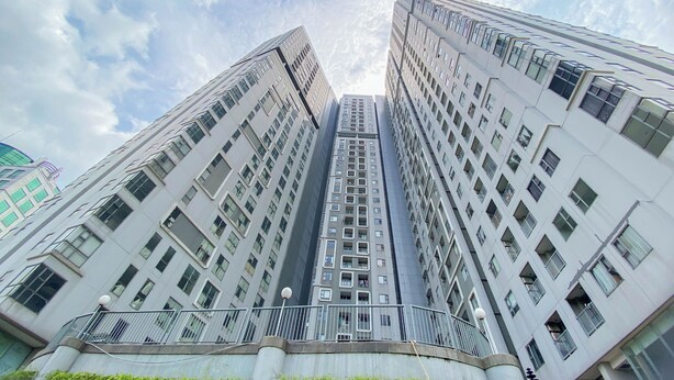 A high-rise building with multiple floors, large windows, and a modern architectural design. - Homey and Modern 2BR Apartment at Royal Olive Residence (Jakarta)