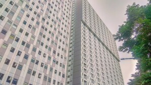 A high-rise building with a grid of windows and balconies.