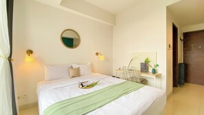 Relax in a serene space with a comfortable bed, a round mirror, and ambient lighting.