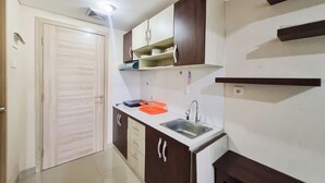 A compact kitchen with a sink, cabinets, and a countertop. - Cozy and Good Place Studio at Taman Melati Sinduadi Apartment (Pogung Lor)