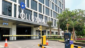 A building entrance with a sign reading "POLLUXMAN" and a "MOTOR" sign indicating a parking area.