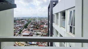 A high-rise building with multiple balconies and large windows. - Cozy Living Studio at Taman Melati Sinduadi Apartment (Pogung Lor)