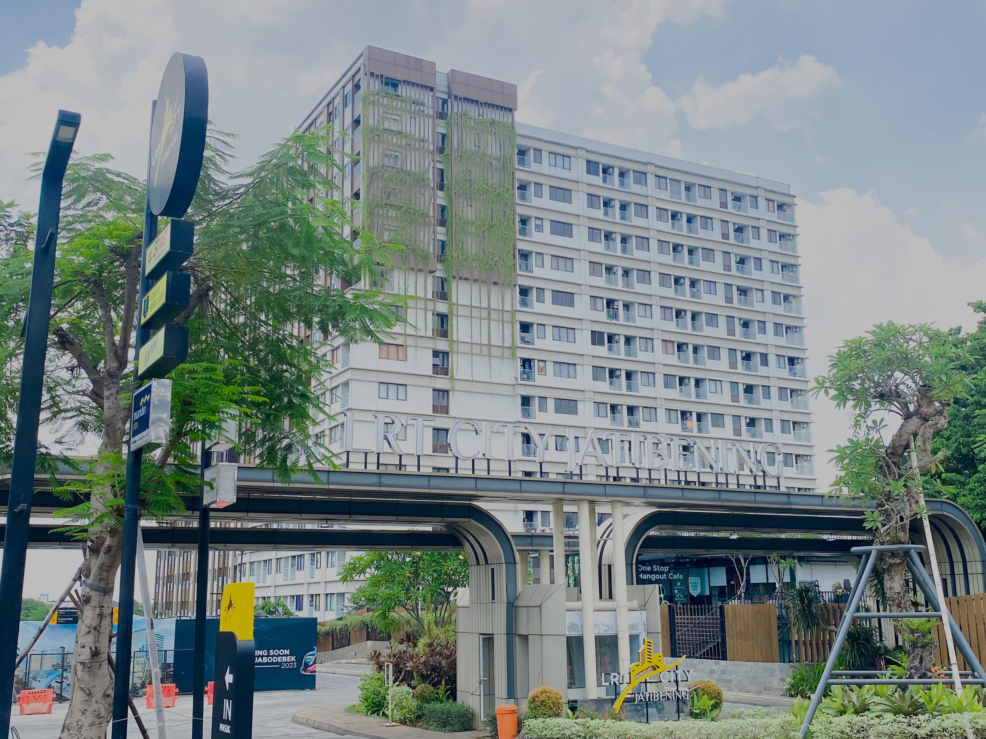 A multi-story hotel with a modern facade, balconies, and a prominent entrance.