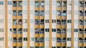 A multi-story residential building with balconies, air conditioning units, and a uniform facade. - Cozy Living Studio at LRT City Jatibening Apartment (Bekasi)