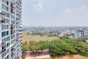 Enjoy breathtaking views of the city from your balcony overlooking a lush park.