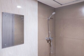 Deluxe Studio (queenbed) | Bathroom | Shower, free toiletries, towels - Modern and Cozy Studio at Apartment Tamansari Bintaro Mansion (South Tangerang)
