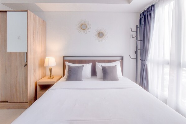 Deluxe Studio (queenbed) | Minibar, bed sheets - Modern and Elegant Studio at Apartment Tamansari Bintaro Mansion (South Tangerang)