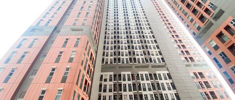 A high-rise building with multiple floors, featuring a mix of architectural styles and window patterns.