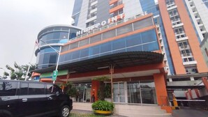 A modern building with a prominent sign reading "The Point." - Good Place and Tidy 2BR at High Point Serviced Apartment (Surabaya)