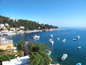 Stroll along the marina, surrounded by boats and lush greenery.