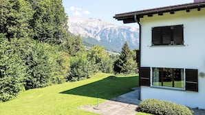 A modern house with a view of mountains.