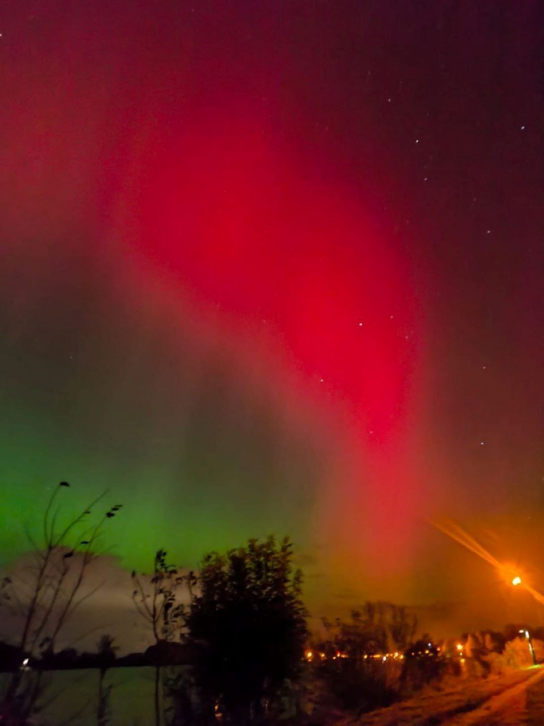 A night scene with a visible aurora display.