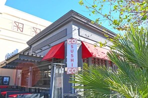A sushi restaurant with a red awning and a signboard. - New 2BR at Horizon at 77th - Pools, Amazing Views! (Myrtle Beach)