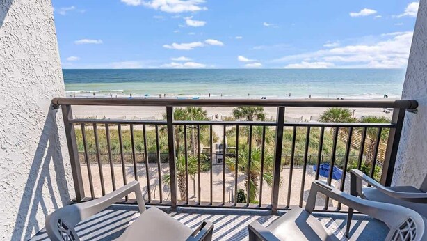 A balcony with a view of the beach and ocean. - NEW, Landmark Direct Oceanfront View - Pools 1BR! (Myrtle Beach)