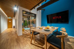 Apartment, Balcony | Living area | 85-inch flat-screen TV with digital channels, TV, video-game console