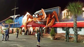 A large crab mascot outside a building with a sign that reads "GIANT CRAB". - 1BR Sea Villas in Windy Hill - Steps to the Beach! (North Myrtle Beach)