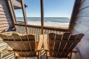 A wooden deck with two Adirondack chairs facing a beach view. - Private Tilghman Beach & Racquet Direct Oceanfront (North Myrtle Beach)