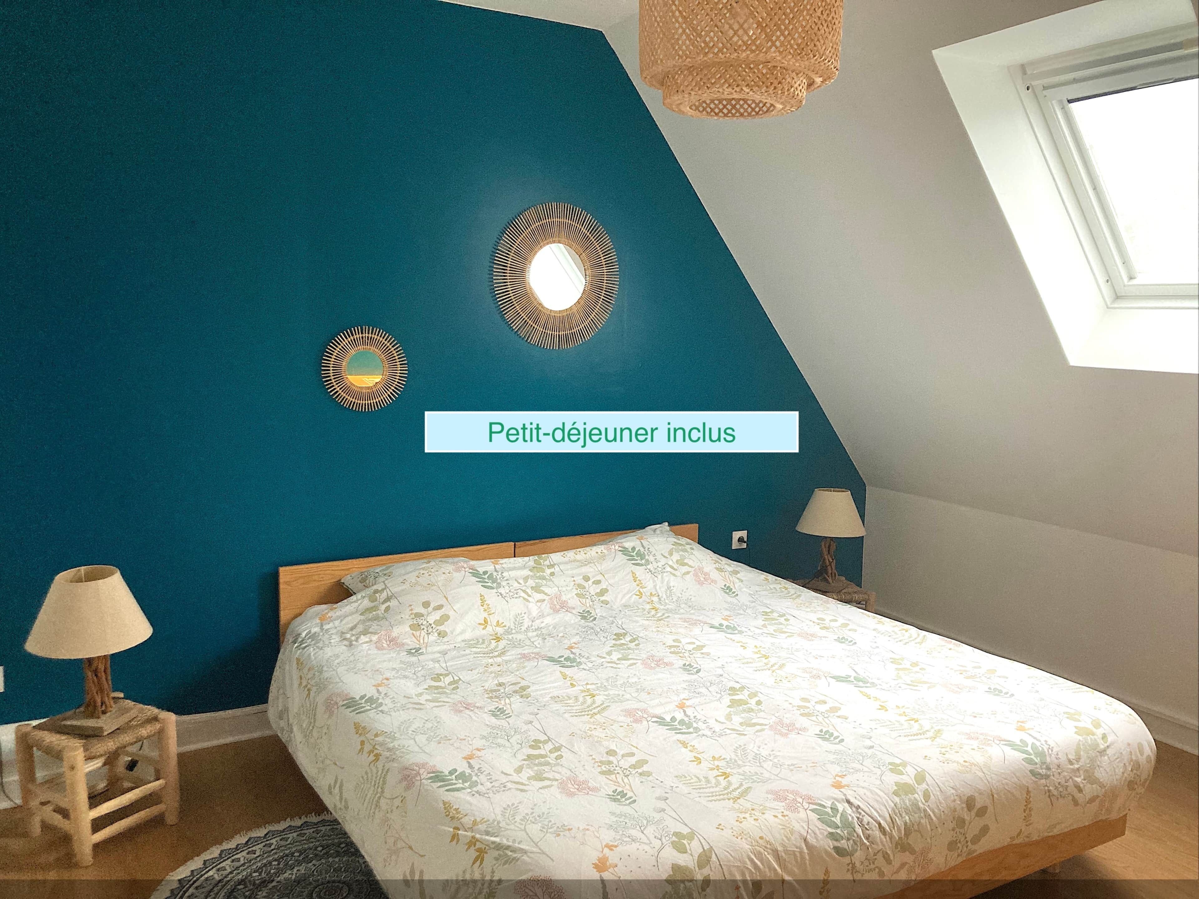 A bedroom with a bed, two bedside tables, a lamp, and a window.