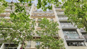 A multi-story building with balconies, large windows, and a classical architectural style. - Incredible Apartment  Etoile Porte Maillot (Paris)