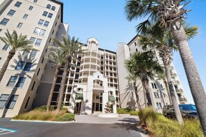 A multi-story hotel with a central courtyard, palm trees, and a fountain. - Florencia 505 by Liquid Life (Pensacola)