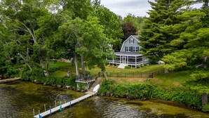 A lakeside house with a dock and a covered walkway. - Winnipesaukee waterfront escape with private dock and guest cottage (Tuftonboro)