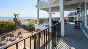 A beachfront property with a pool, outdoor seating, and a view of the ocean. - Oceanfront 8 BR Beach House with a Private Pool! Haven of Rest (Murrells Inlet)