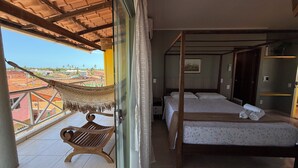 A balcony with a hammock, a wooden bench, and a bed with a canopy. - POUSADA O PORTUGA (São Miguel dos Milagres)