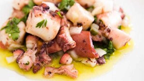 A dish with octopus, potatoes, and herbs. - POUSADA O PORTUGA (São Miguel dos Milagres)