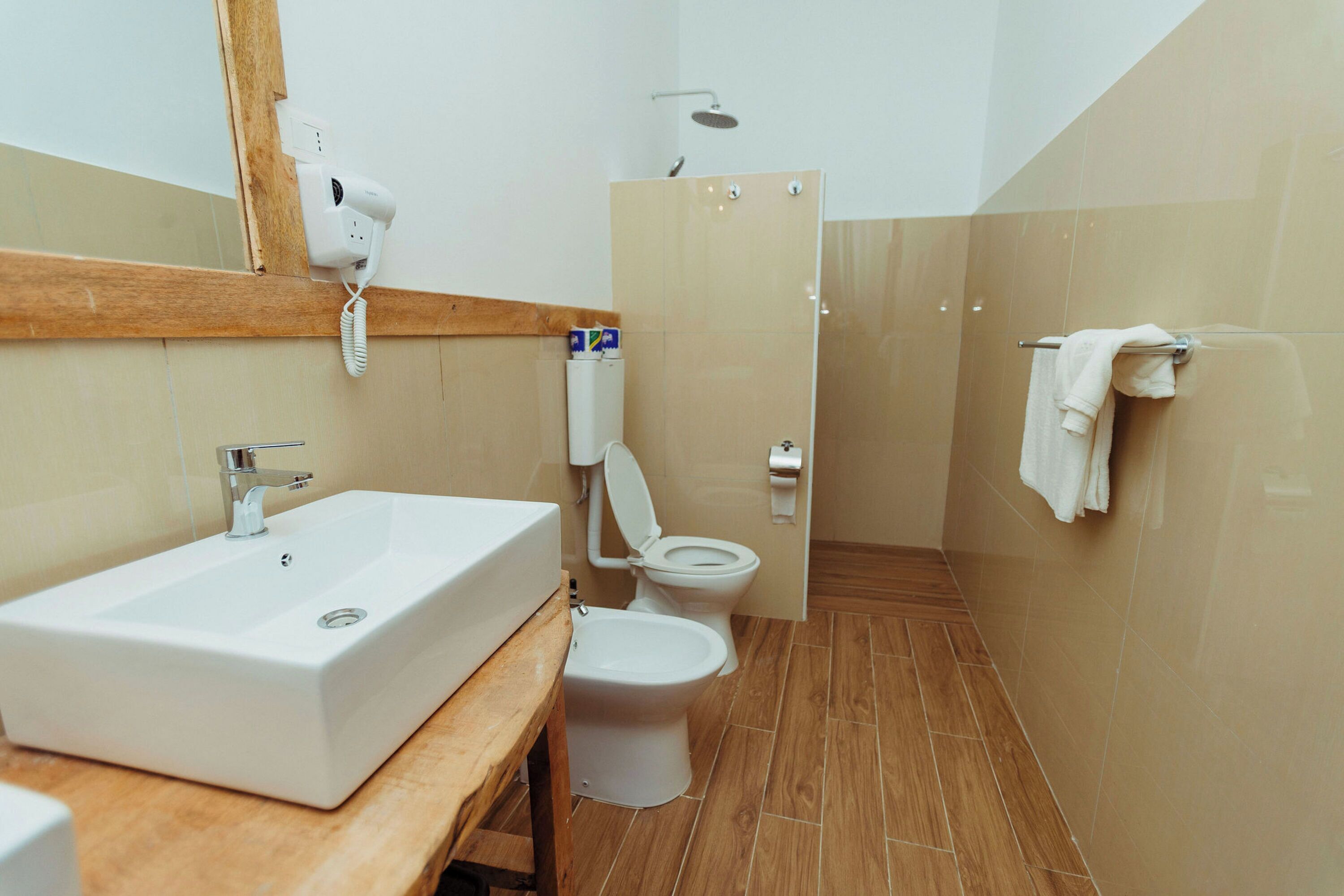 A bathroom with a sink, toilet, and shower.