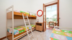 A room with bunk beds, a small desk, a chair, and a window with a view. - Cozy apartment with breathtaking views in Positano. CIN IT065100C2D8D7L43H (Positano)