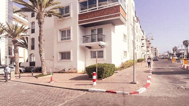 A multi-story building with a flat roof, balconies, and a mix of windows and doors. - ZAYANE HOMES AGADIR (Agadir)
