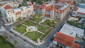 An aerial view of a historic building complex with a central courtyard, surrounded by roads and other buildings. - Bright 4BR Home - Just Minutes from town & Beach! (St. Augustine)