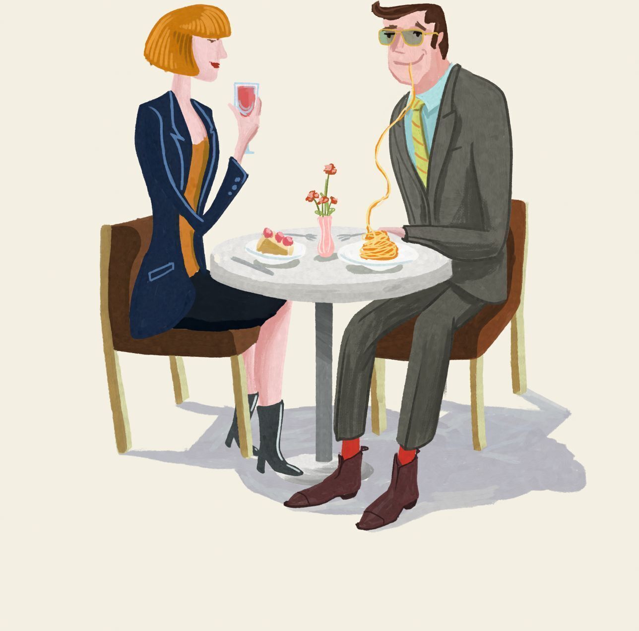 A man and a woman sitting at a round table with a vase of flowers, plates of food, and a glass of red drink.