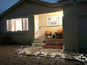 A house with a covered porch, steps leading to a door, and outdoor furniture. - 4 Bed 2 Bath House Near Everything in San Diego.  (San Diego)