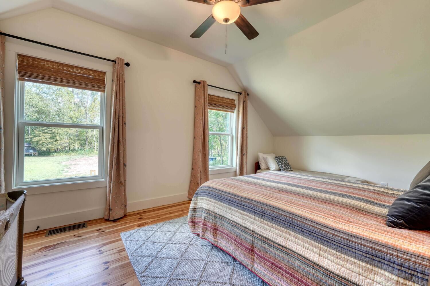 Upstairs large bedroom with queen bed and a folding twin bed.