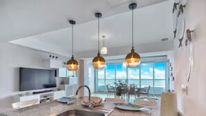 A modern kitchen with a granite countertop, stainless steel sink, and pendant lighting. - Beautiful 2-bedroom condo in fabulous Guayacanes with WiFi, AC (Guayacanes)