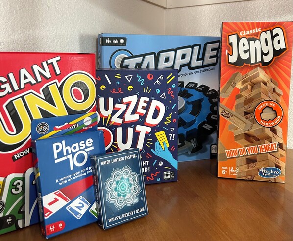 A collection of board games including Giant UNO, Phase 10, and Jenga.