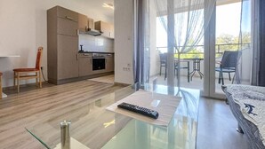 A modern living room with a glass coffee table, a remote control, and a sofa. - Stunning apartment in Bibinje with WiFi (Bibinje)