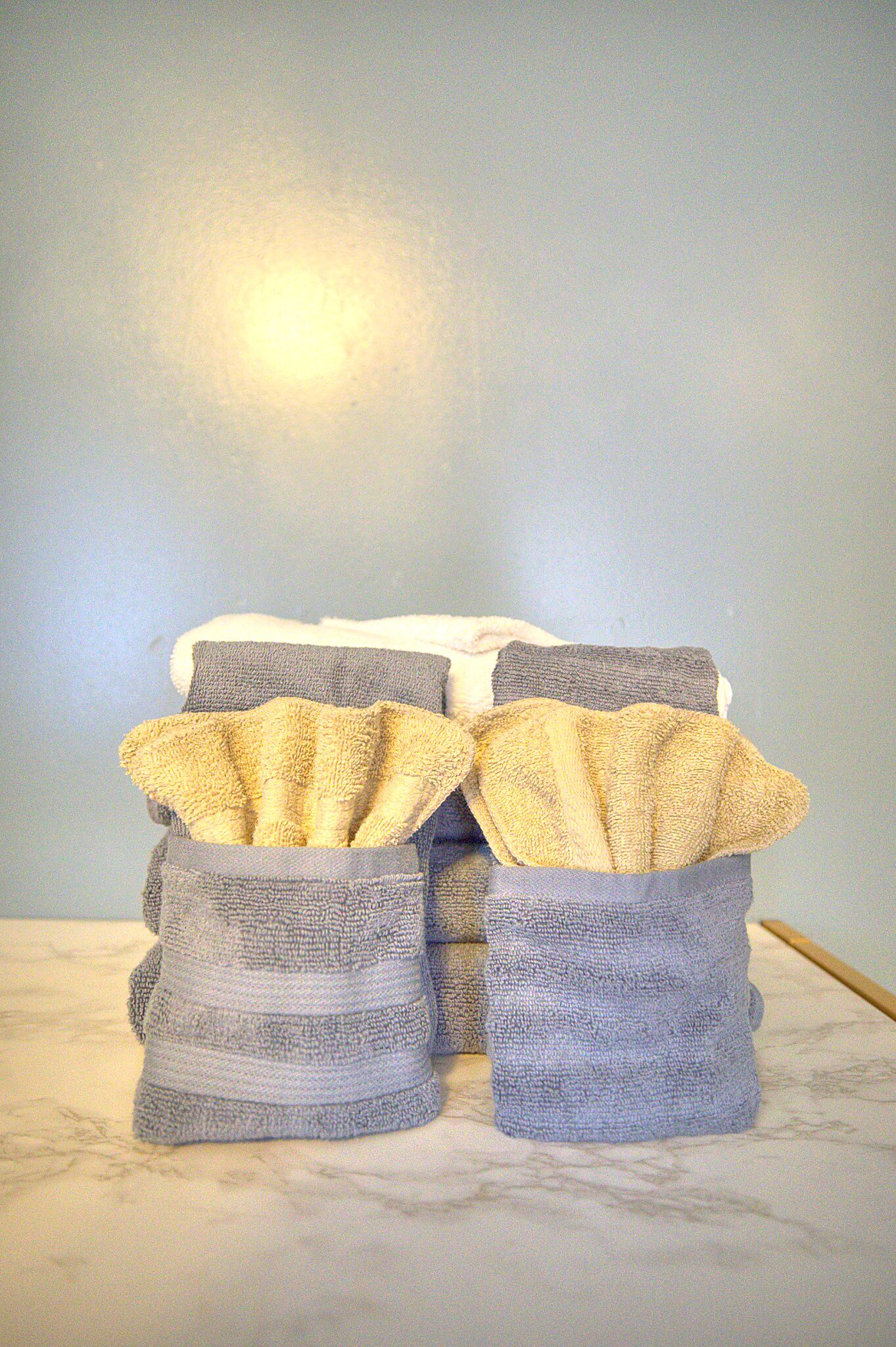 A stack of towels in a bathroom setting.