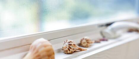 A window sill with decorative shells.