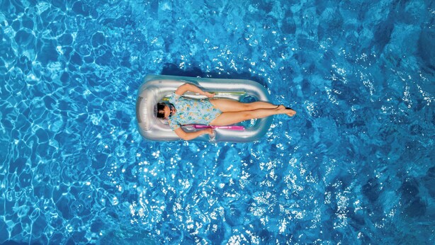 A person floating on an inflatable pool float in a clear blue pool. - BIG4 Red Cliffs Holiday Park (Red Cliffs)