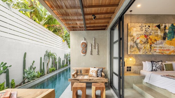 A modern bedroom with a pool, wooden furniture, and a large mural. - Ubud Lila Concept (Ubud)