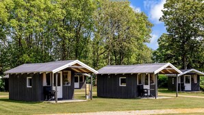 Three small cabins with wooden exteriors and metal roofs, each with a porch and a window. - 4 Person Holiday Park Home in Jelling (Jelling)