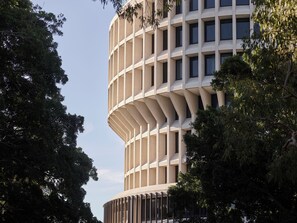 A modern building with a unique curved facade and large windows. - Crystalbrook Kingsley (Newcastle)