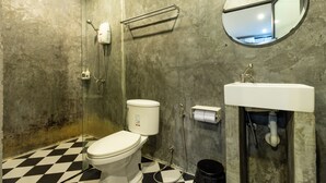 A bathroom with a toilet, a shower, and a sink. - The Secret Service Hotel (Bangkok)