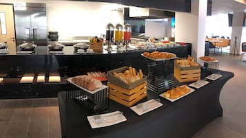 A buffet setup with various food items and beverages.