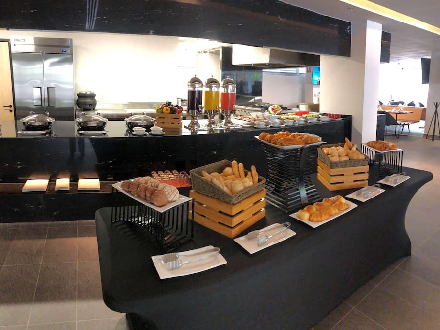 A buffet setup with various food items and beverages.